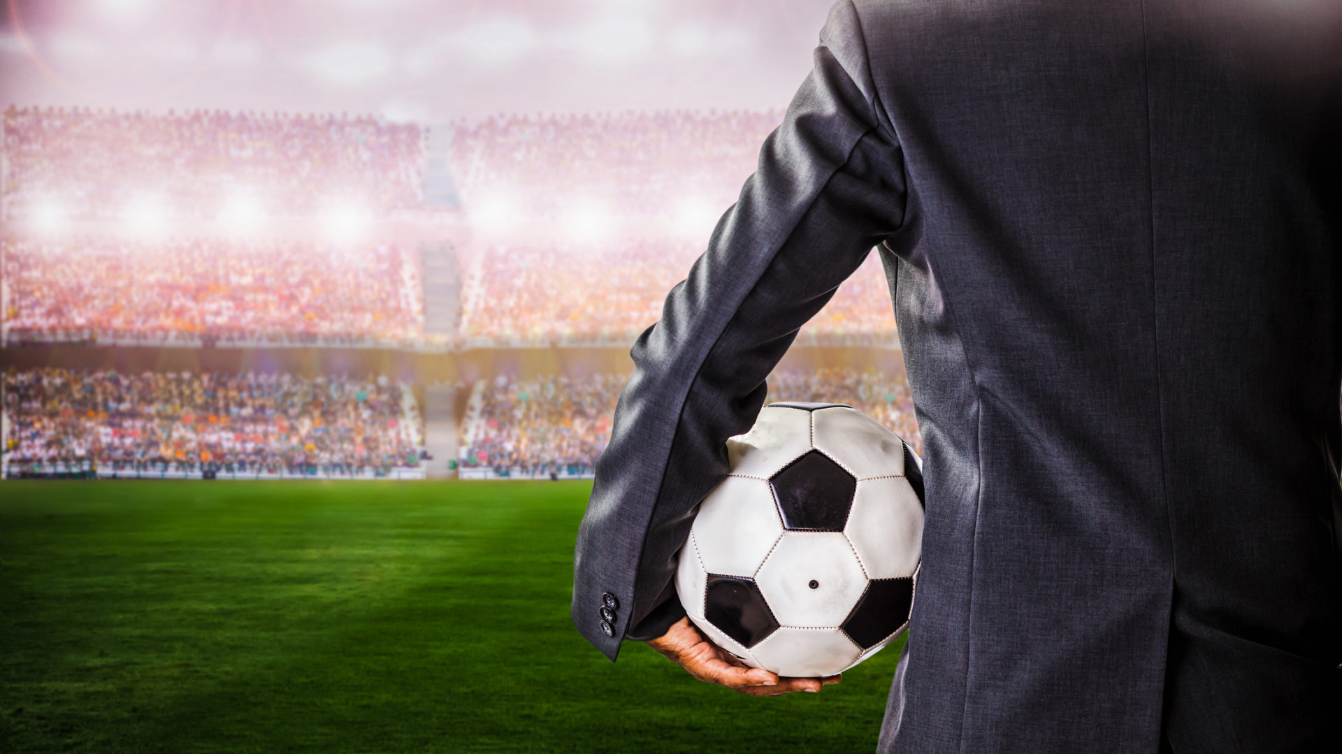 soccer manager against supporters in the stadium